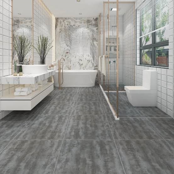 Luxury modern bathroom design featuring dark grey floor tiles, white subway wall tiles, glass shower screen, wall-mounted toilet, floating vanity, and a tub.